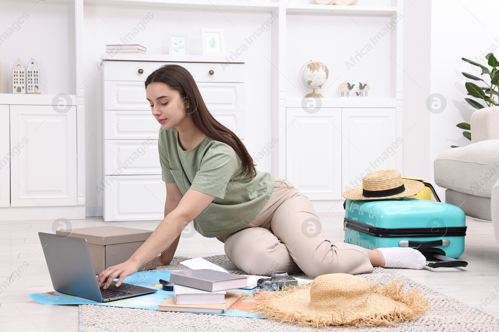 Photo of Travel blogger using laptop for planning trip at home