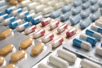 Photo of Antibiotic pills in blisters as background, closeup