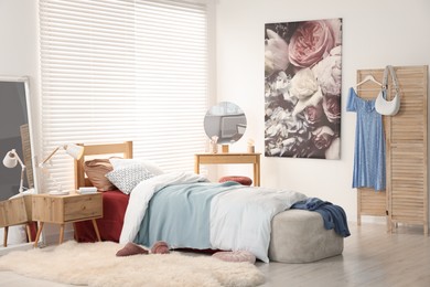 Teen's room interior with modern furniture and beautiful picture on wall