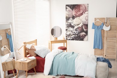 Teen's room interior with modern furniture and beautiful picture on wall