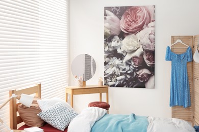 Teen's room interior with modern furniture and beautiful picture on wall