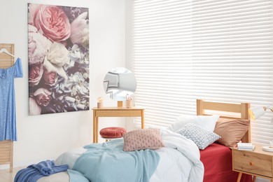 Teen's room interior with modern furniture and beautiful picture on wall