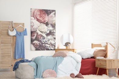 Photo of Teen's room interior with modern furniture and beautiful picture on wall