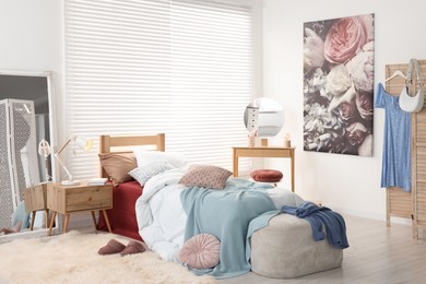 Teen's room interior with modern furniture and beautiful picture on wall