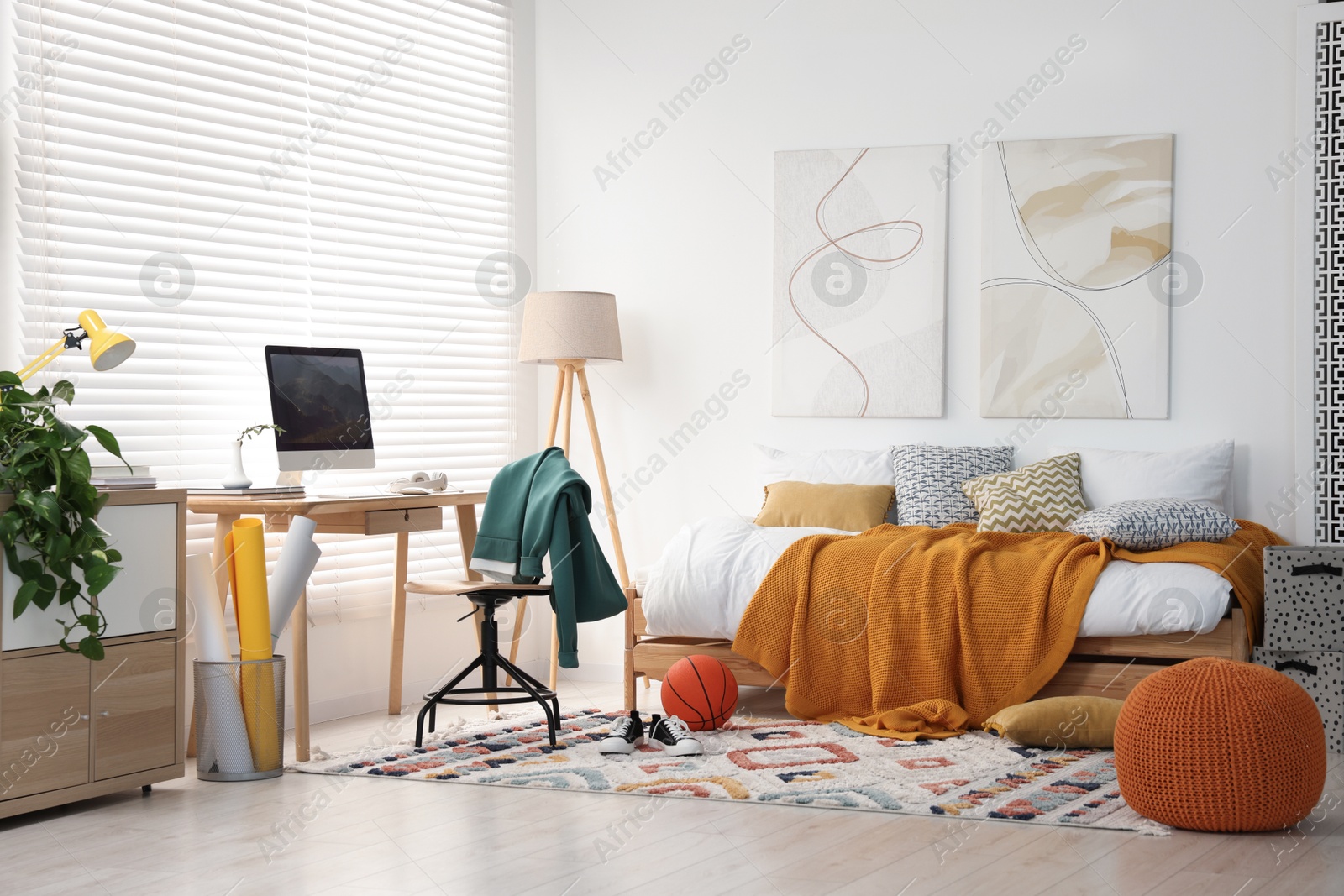 Photo of Teen's room interior with modern furniture and beautiful pictures on wall