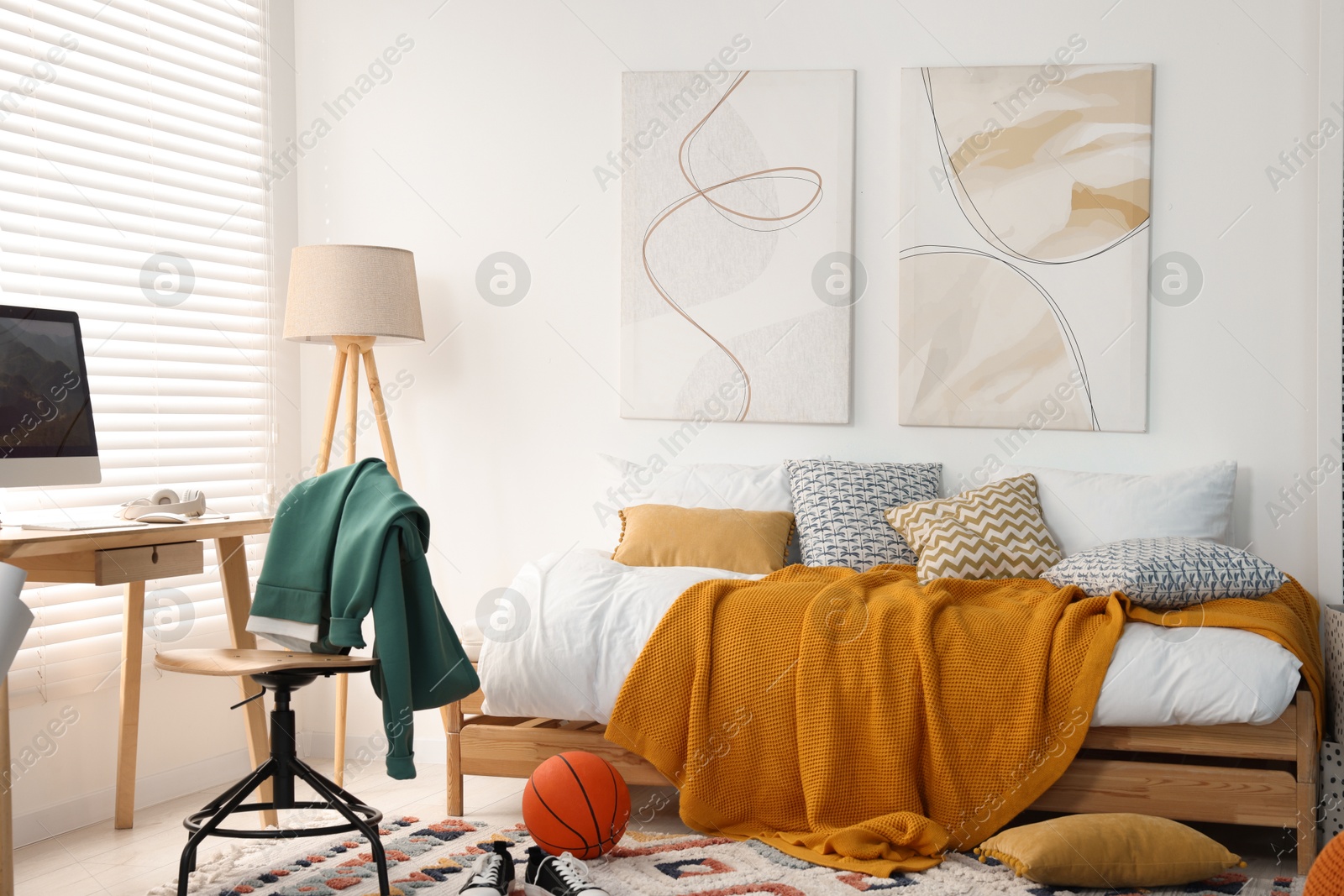 Photo of Teen's room interior with modern furniture and beautiful pictures on wall