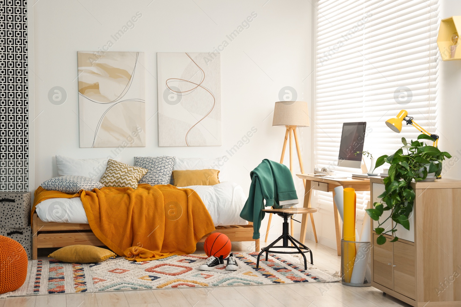 Photo of Teen's room interior with modern furniture and beautiful pictures on wall