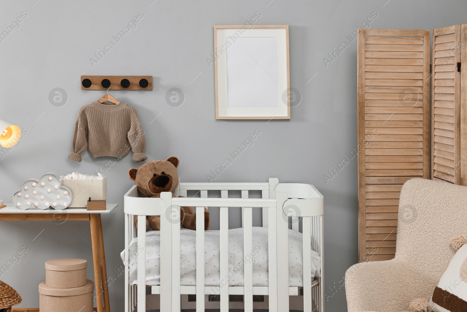 Photo of Newborn baby room interior with stylish furniture and comfortable crib