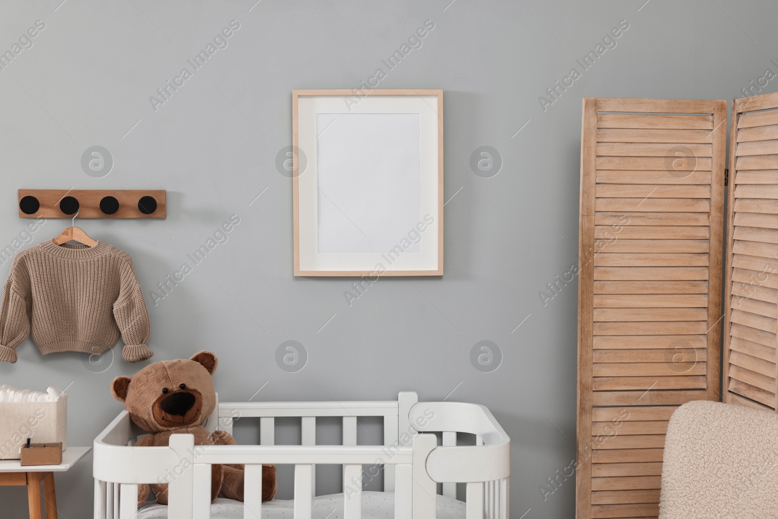 Photo of Newborn baby room interior with stylish furniture and comfortable crib