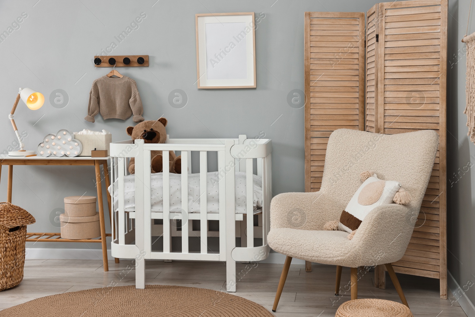 Photo of Newborn baby room interior with stylish furniture and comfortable crib