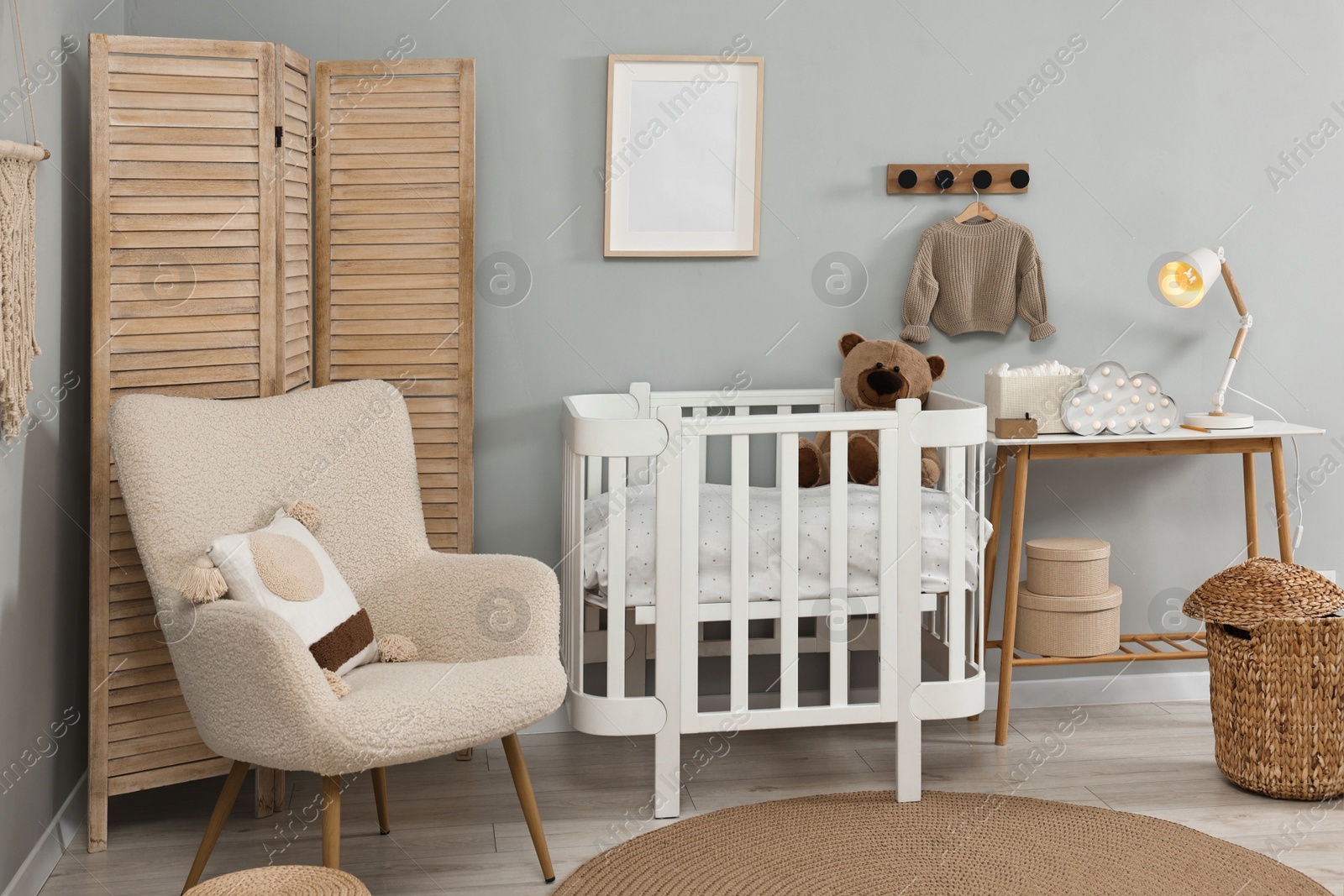 Photo of Newborn baby room interior with stylish furniture and comfortable crib