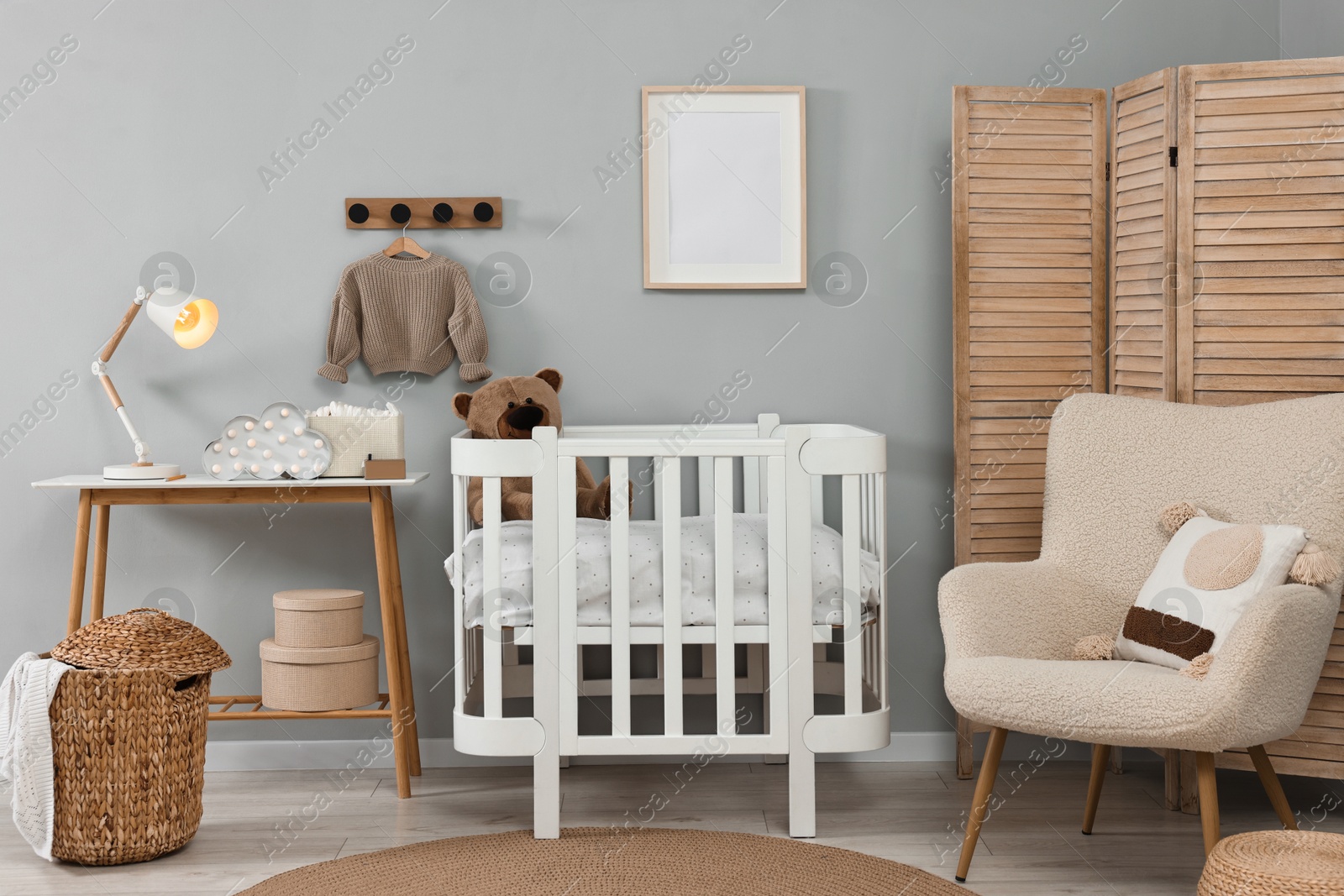 Photo of Newborn baby room interior with stylish furniture and comfortable crib