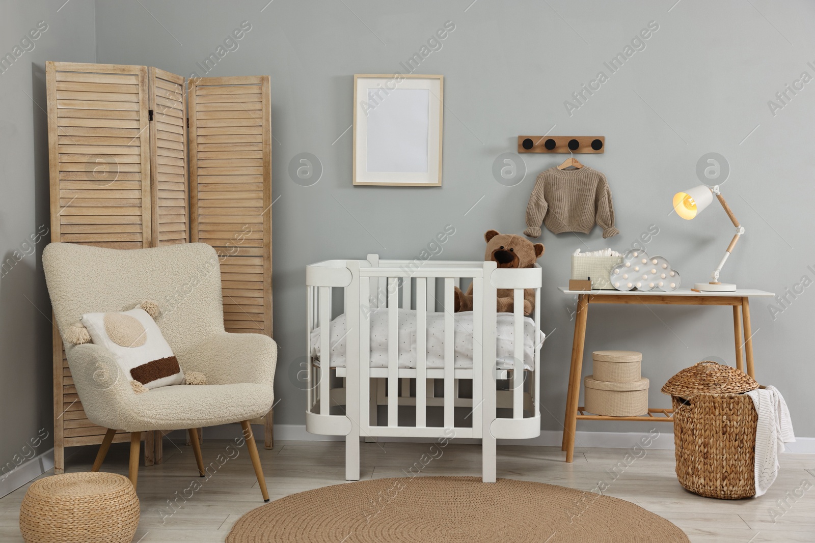 Photo of Newborn baby room interior with stylish furniture and comfortable crib