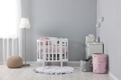 Photo of Newborn baby room interior with stylish furniture and comfortable crib