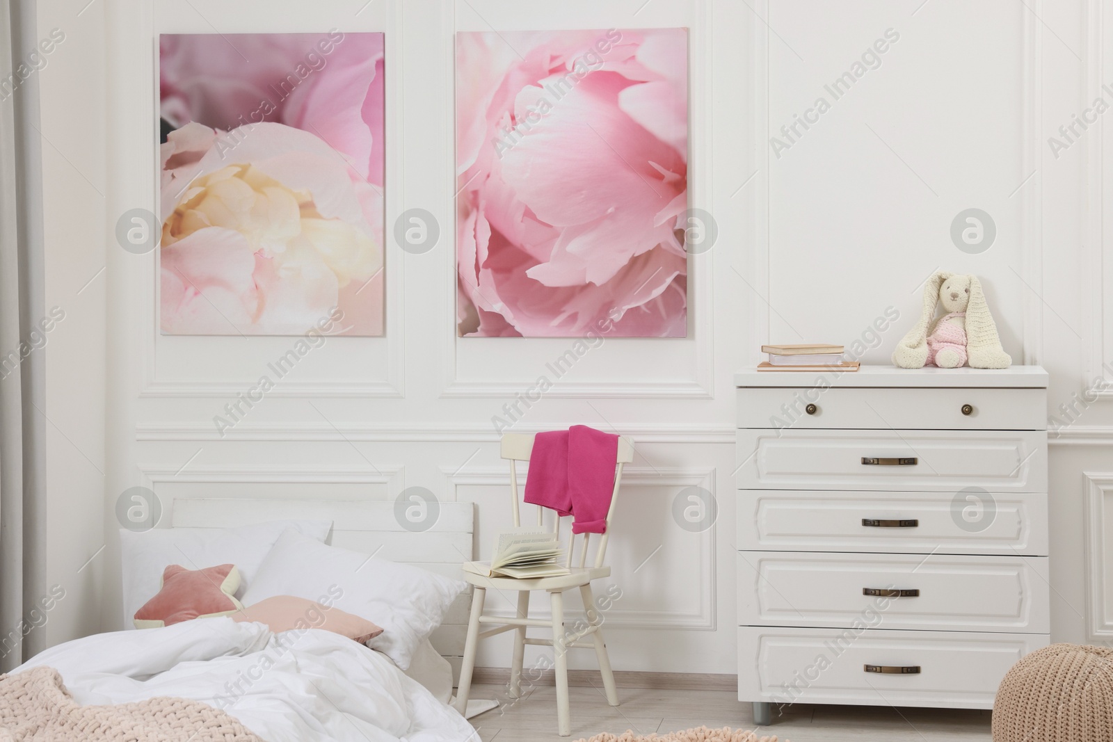 Photo of Cute child's room interior with modern furniture and beautiful pictures of on wall