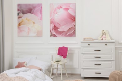 Cute child's room interior with modern furniture and beautiful pictures of on wall