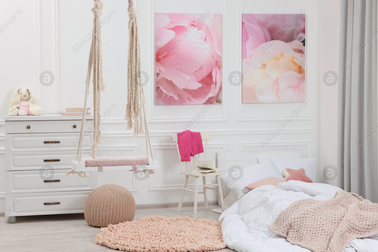 Photo of Cute child's room interior with swing and beautiful pictures of on wall