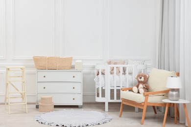 Newborn baby room interior with stylish furniture and comfortable crib