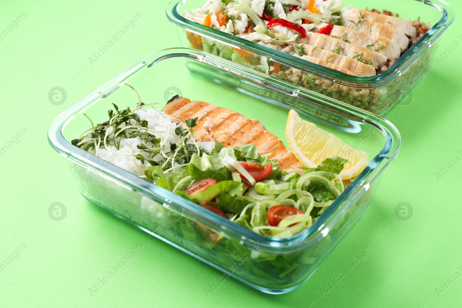 Photo of Healthy meal. Different products in glass containers on green background