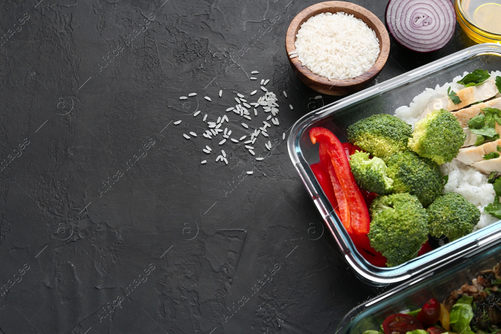 Photo of Healthy meal. Fresh broccoli, chicken, rice and pepper in glass container near other products on black table, space for text