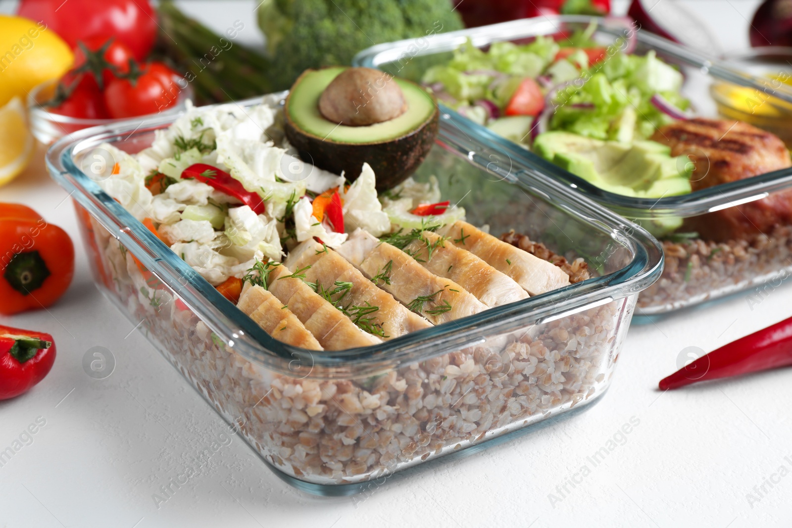 Photo of Healthy diet. Different meals in glass containers and products on white background, closeup