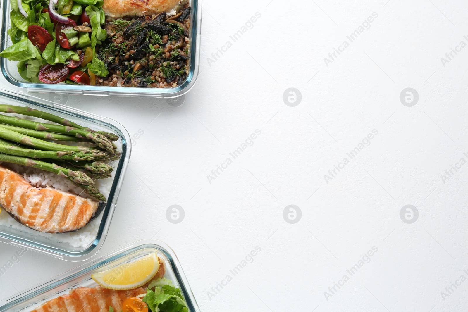 Photo of Healthy food. Different meals in glass containers on white background, flat lay. Space for text