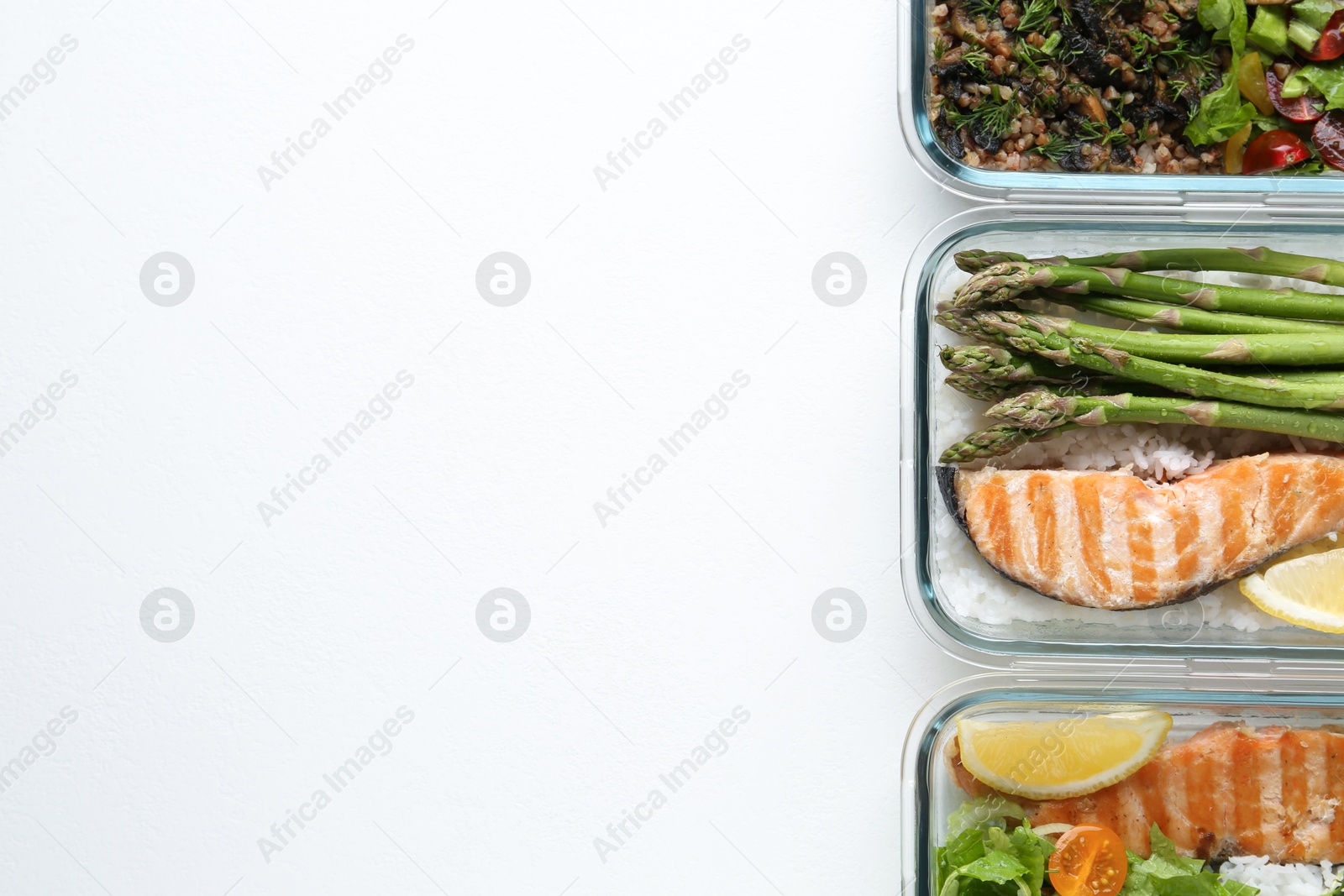 Photo of Healthy food. Different meals in glass containers on white background, flat lay. Space for text