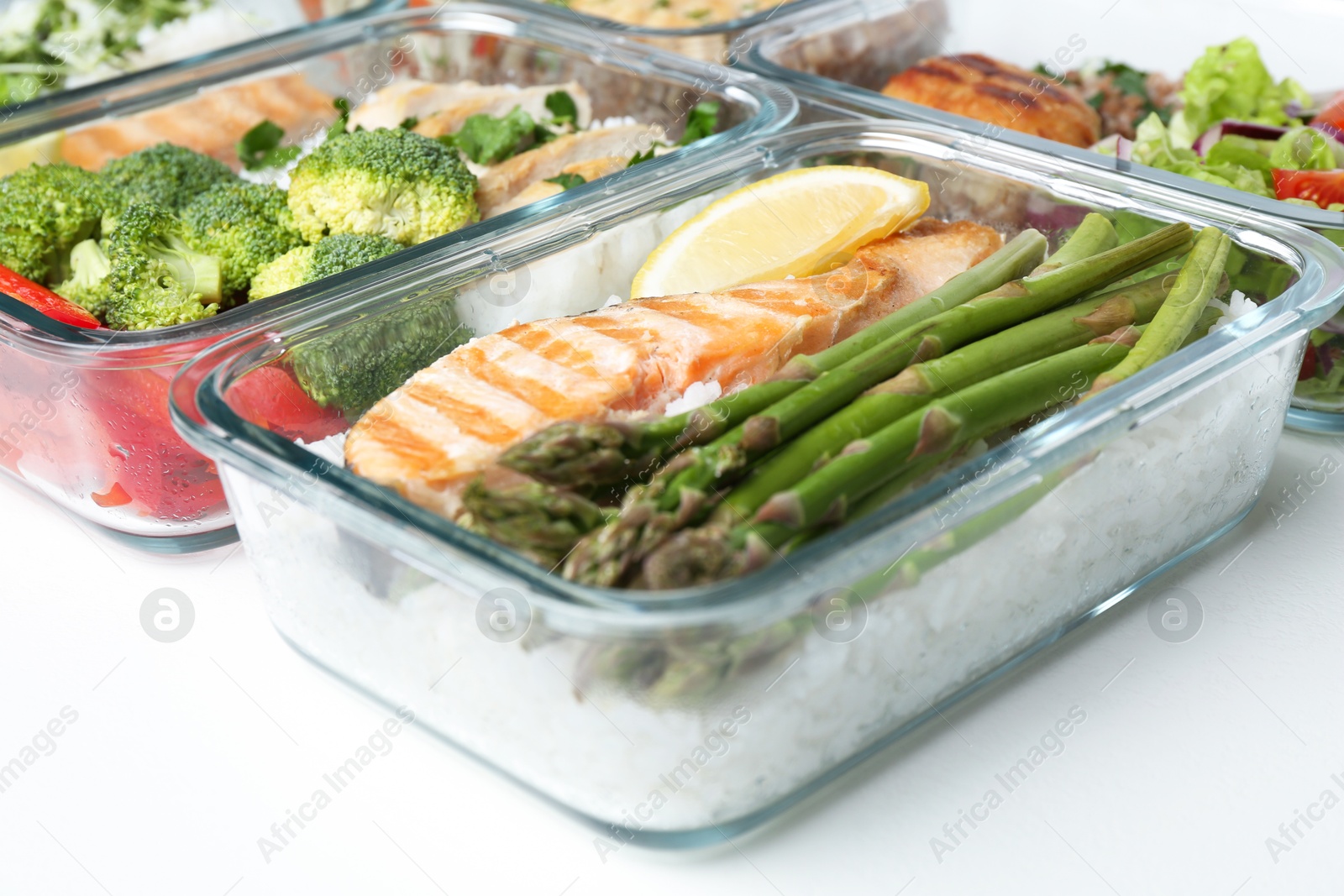 Photo of Healthy food. Different meals in glass containers on white background, closeup