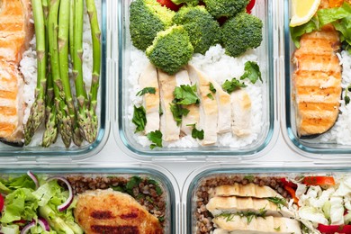 Photo of Healthy food. Different meals in glass containers on table, flat lay