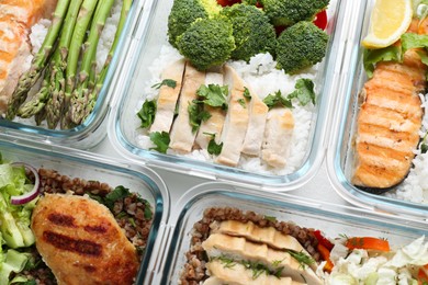 Photo of Healthy food. Different meals in glass containers on table, flat lay