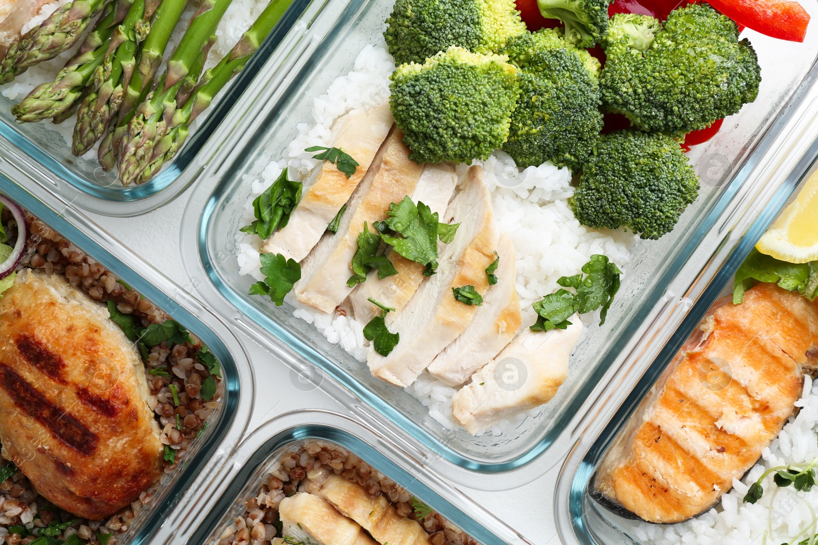 Photo of Healthy food. Different meals in glass containers on table, flat lay