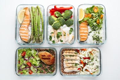 Photo of Healthy food. Different meals in glass containers on white background, flat lay