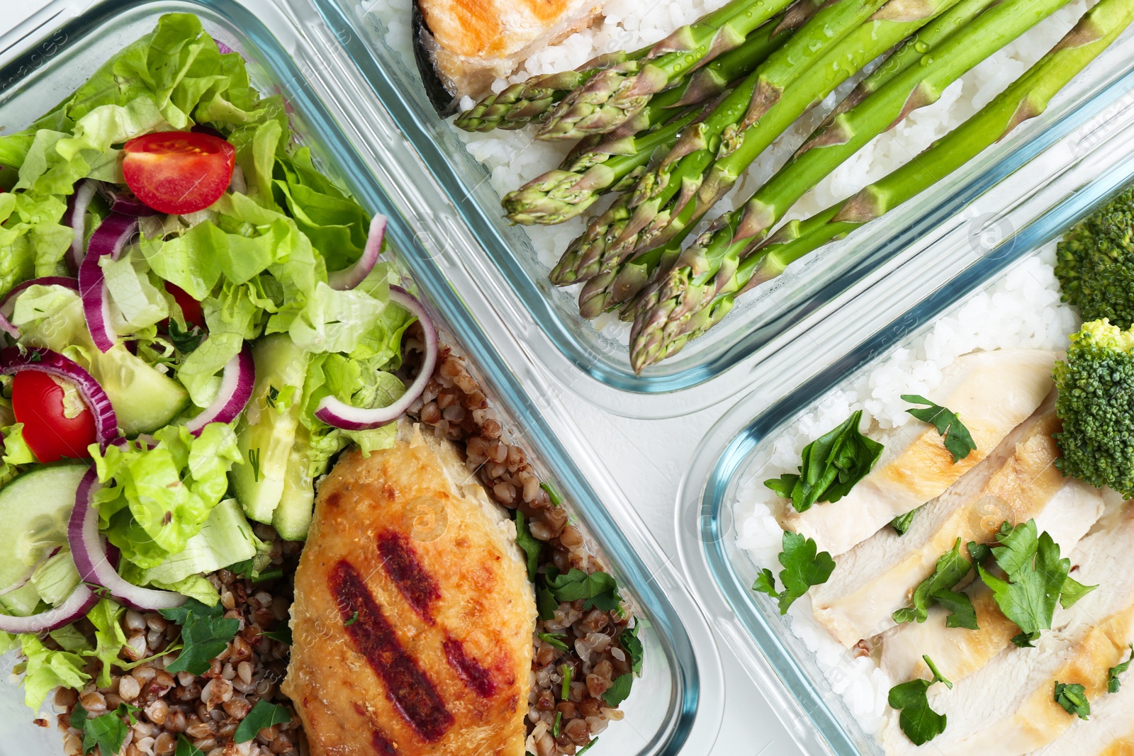 Photo of Healthy food. Different meals in glass containers on table, flat lay