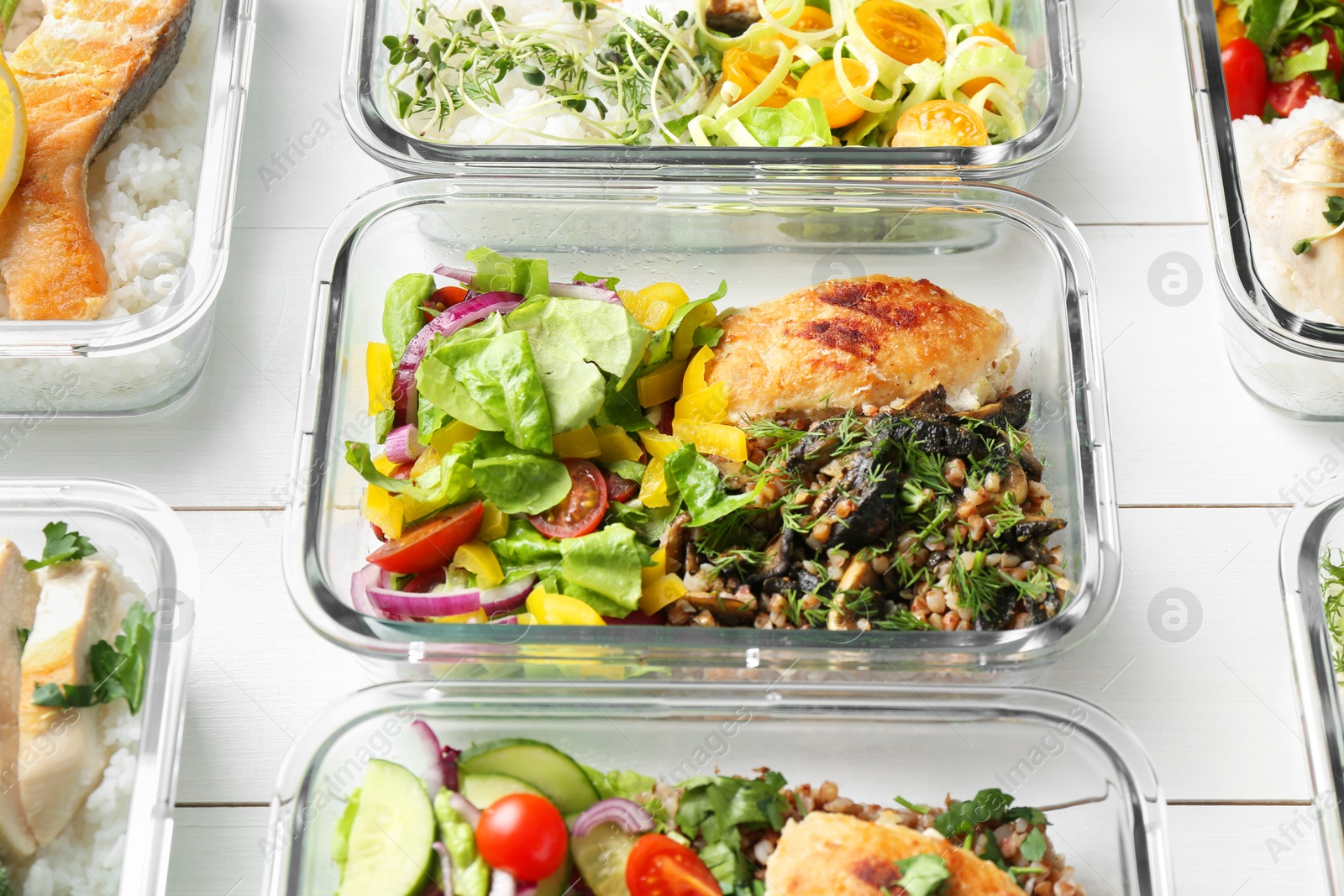 Photo of Healthy meal. Containers with different products on white wooden table