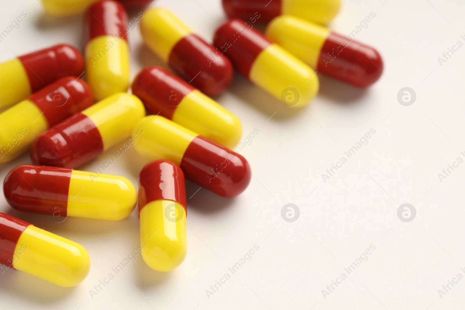 Photo of Antibiotic pills on white background, closeup. Space for text