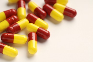 Photo of Antibiotic pills on white background, closeup. Space for text