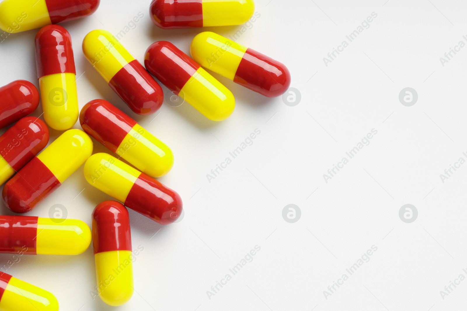 Photo of Antibiotic pills on white background, top view. Space for text