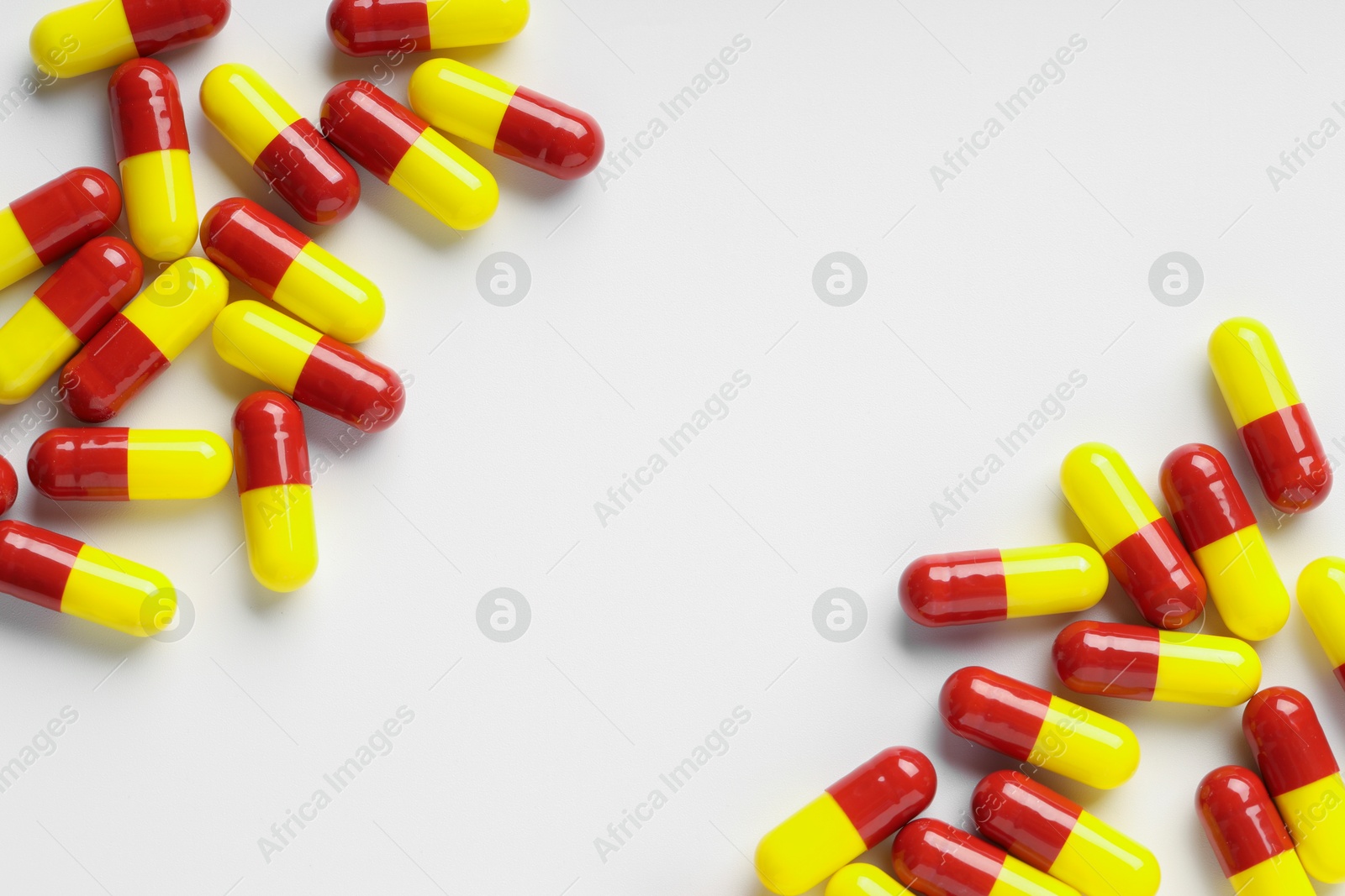 Photo of Antibiotic pills on white background, top view. Space for text