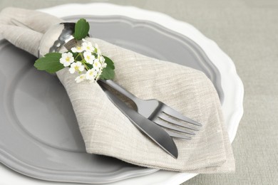 Photo of Stylish setting with cutlery and plates on table, closeup