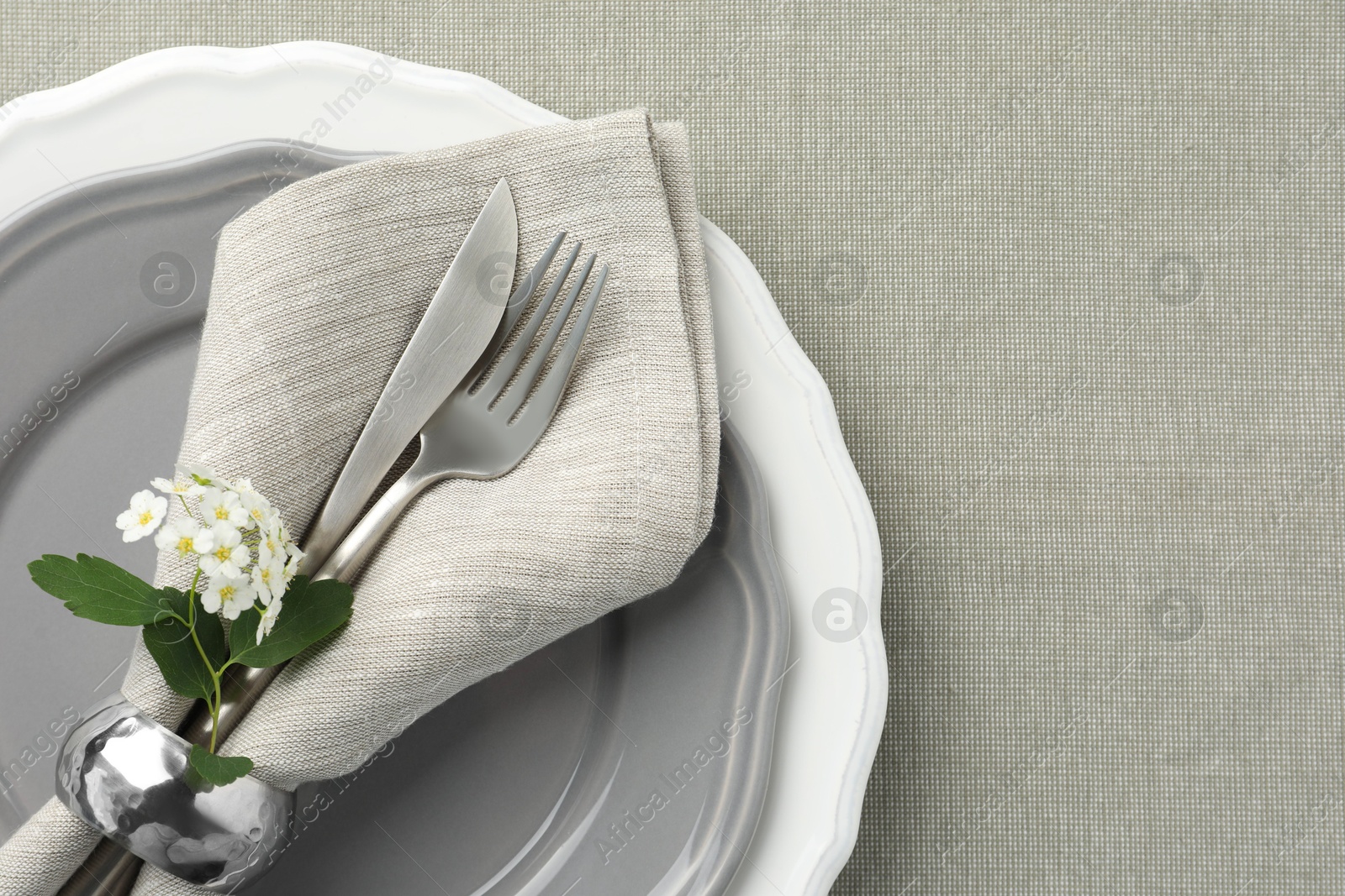 Photo of Stylish setting with cutlery and plates on table, top view. Space for text