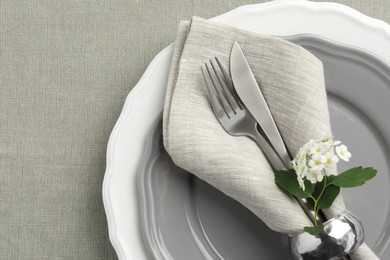 Stylish setting with cutlery and plates on table, top view. Space for text