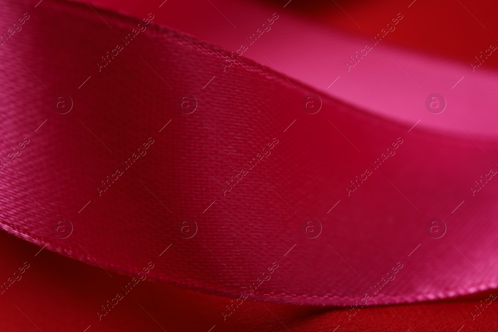 Photo of Beautiful crimson ribbon as background, closeup view