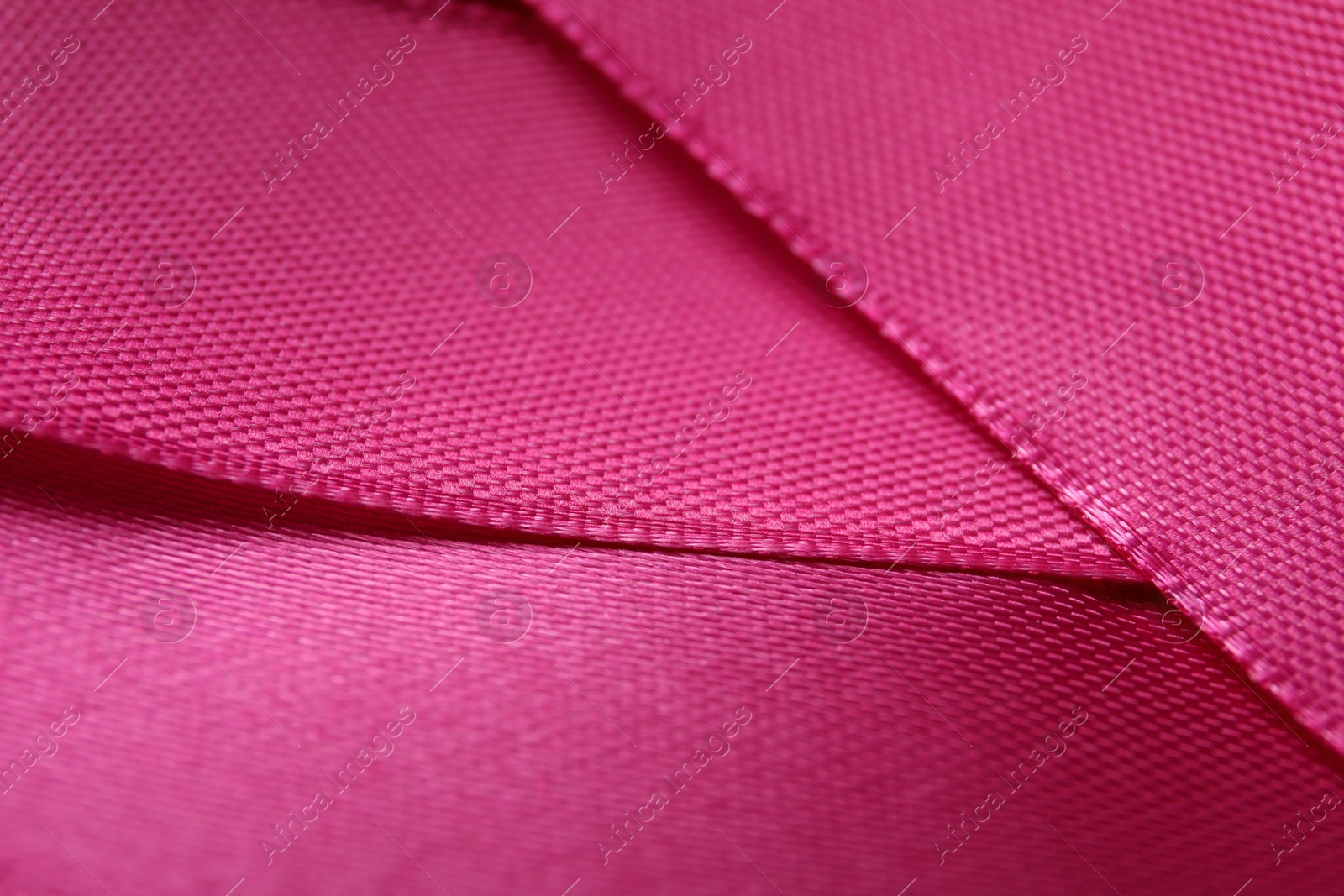 Photo of Beautiful crimson ribbon as background, closeup view