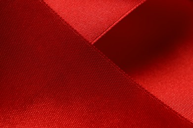 Beautiful red ribbon as background, closeup view