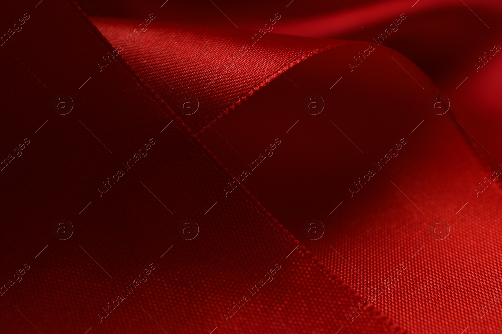 Photo of Beautiful red ribbon as background, closeup view