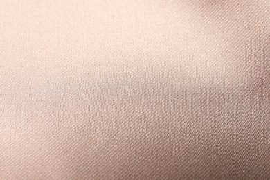 Beautiful beige ribbon as background, closeup view