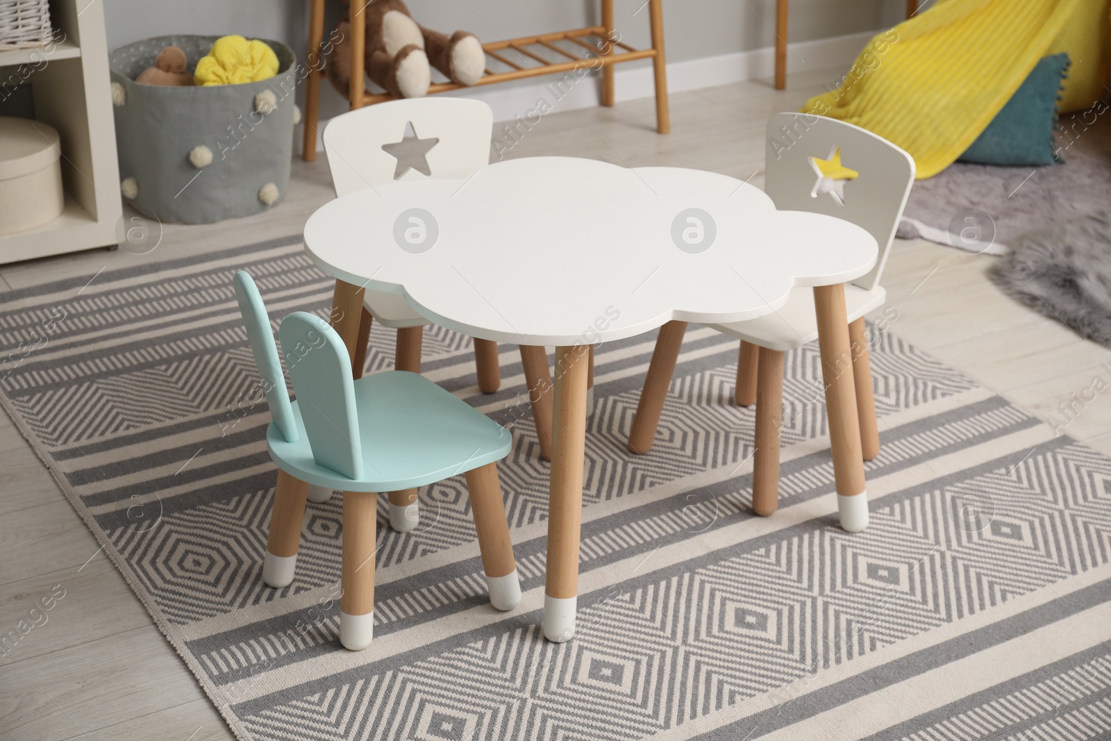 Photo of Stylish child room interior with table and chairs