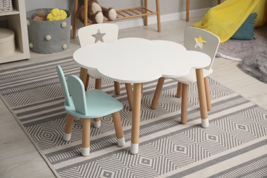 Stylish child room interior with table and chairs