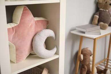 Shelving unit with soft toys in child room. Interior design