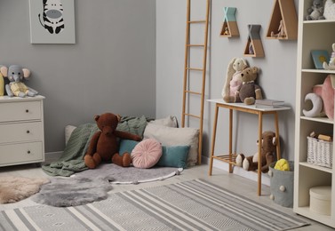 Stylish child room interior with modern furniture and toys